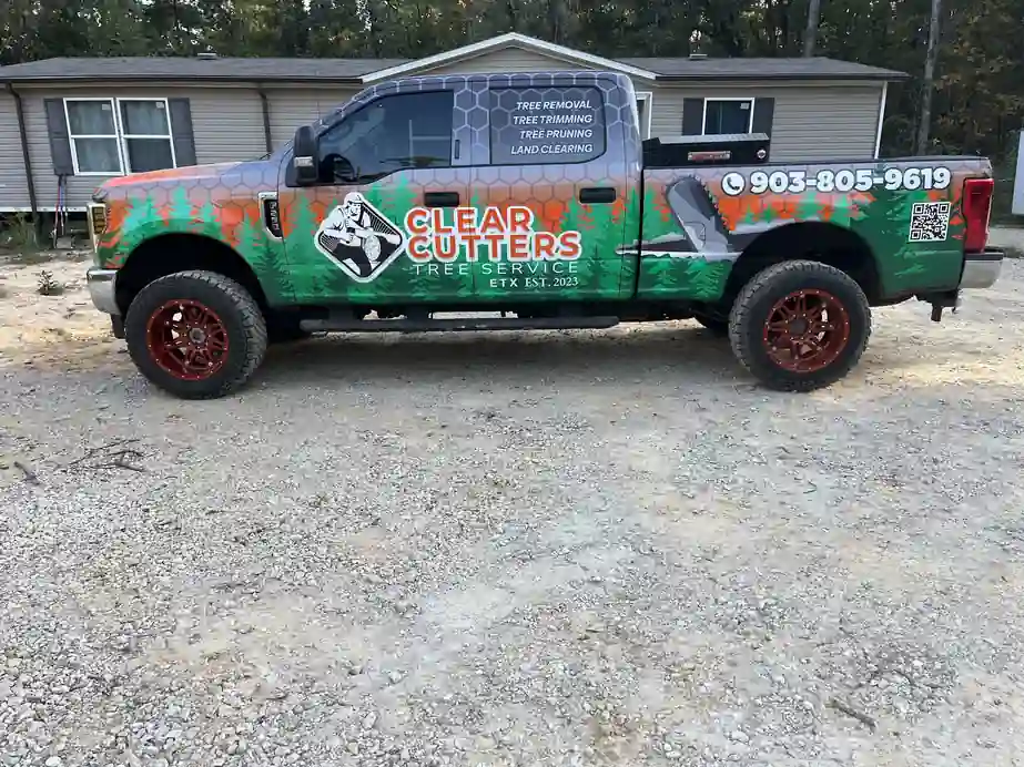 The Clear Cutters F-250 in its graphite honeycomb wrap with pines and orange lettering