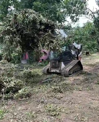 Tracked loader pushing storm debris